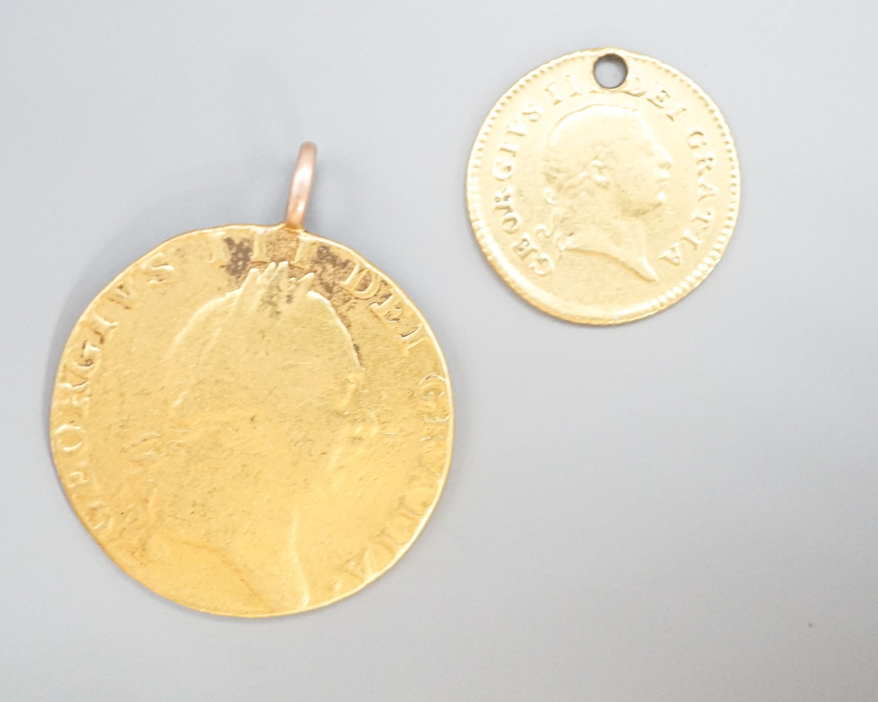 A George III 1788 gold guinea, now with pendant loop and an 1804 gold one third guinea(hole).